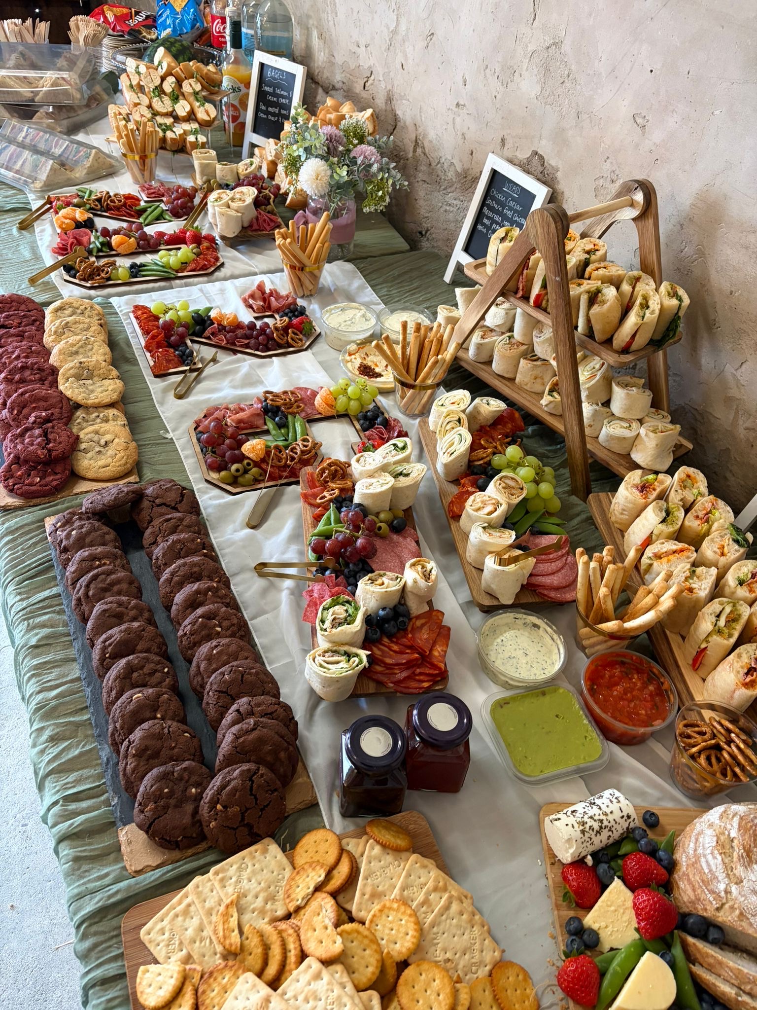 Sharing platters of food laid out at a Tipsy Daisy celebration